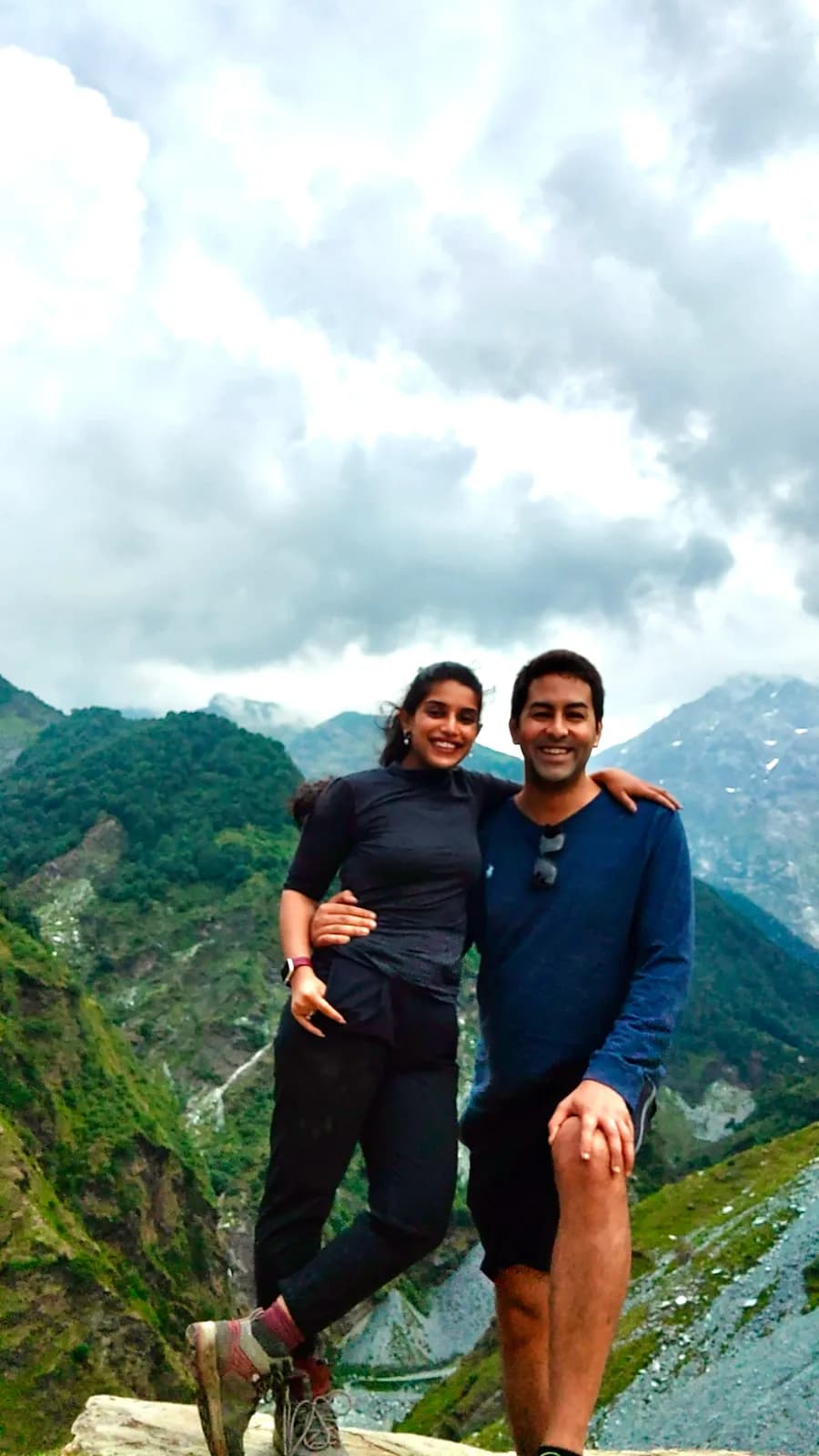 Abhay and his partner on a mountain ridge under cloud