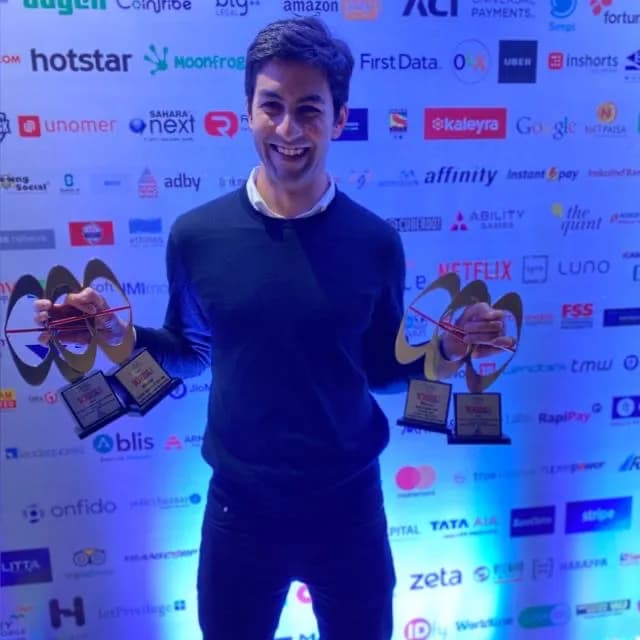 Abhay Singh holding two awards at an industry event
