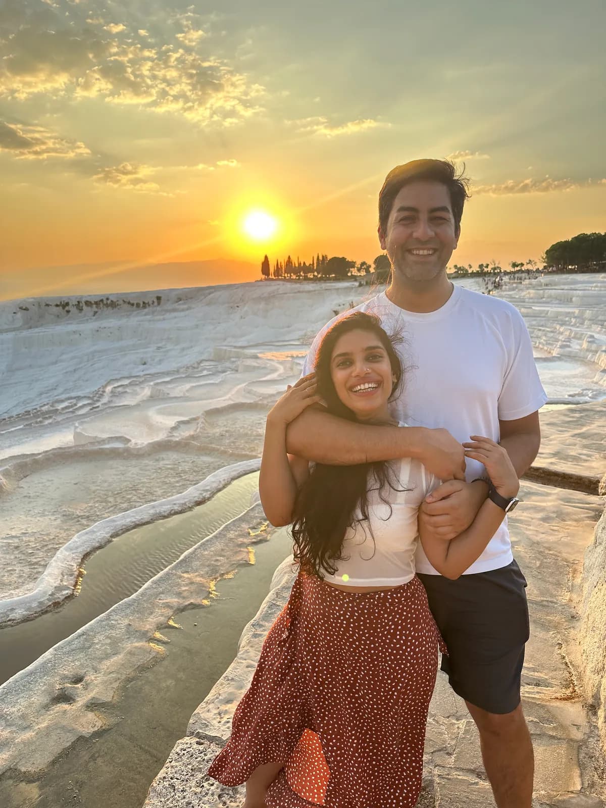 Abhay and his partner at sunset on white mineral terraces